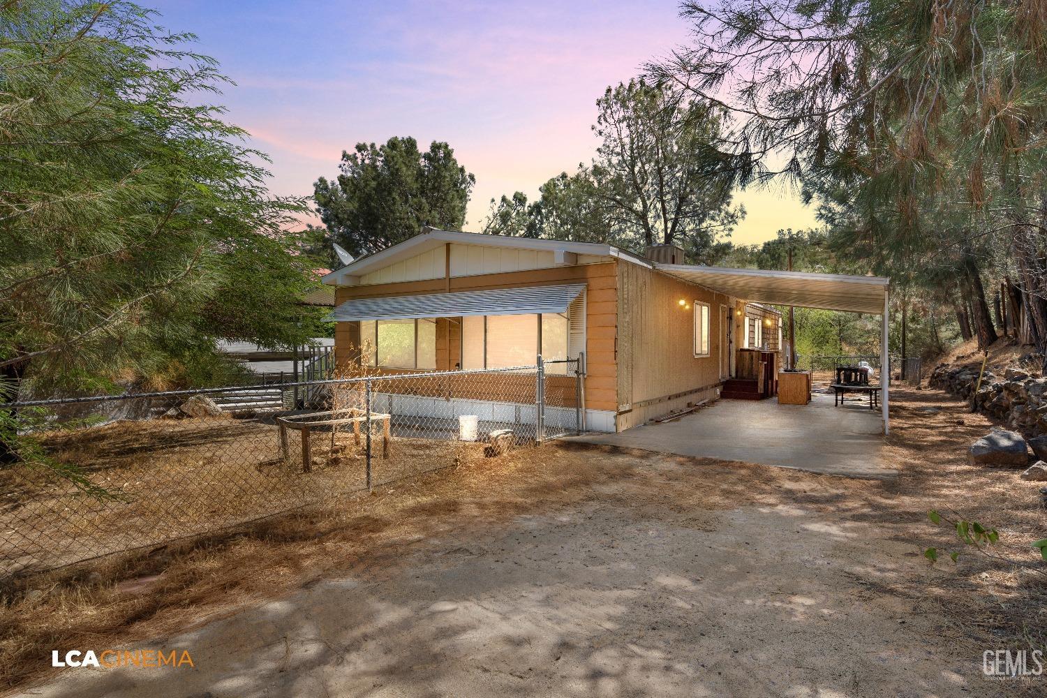 a view of a house with backyard and sitting area