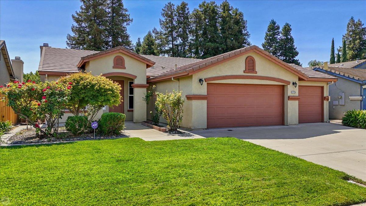 a front view of a house with a yard and garage