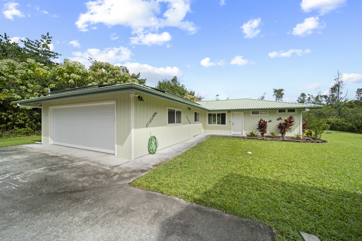 As you approach the front door...well-kept yard with tasteful landscaping and concrete sidewalk