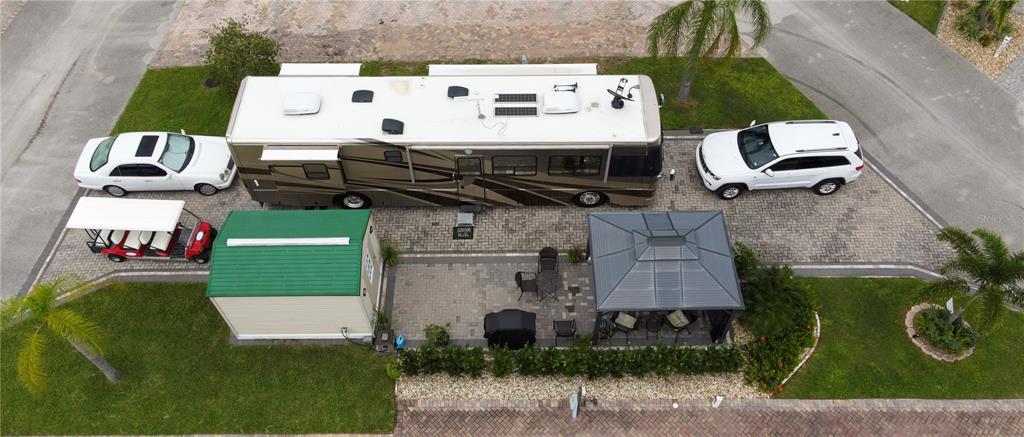 an aerial view of a house with garden space and street view