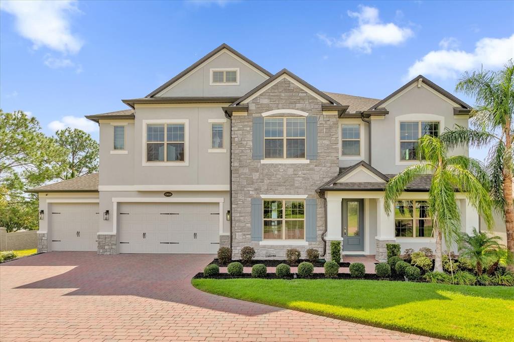 a front view of a house with a yard and garage