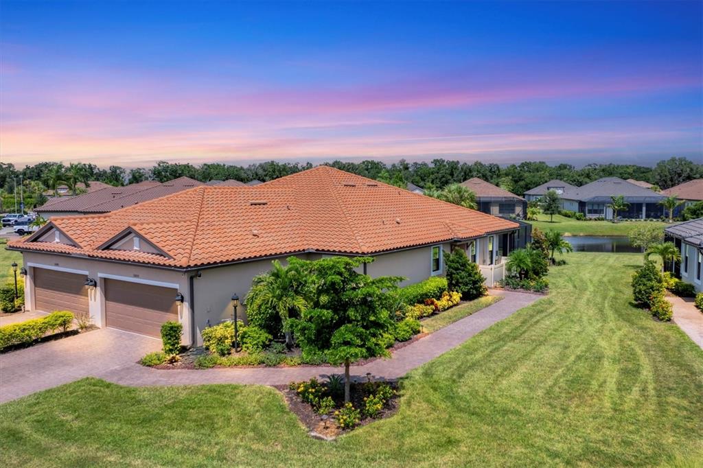 an aerial view of a house with a garden and a yard