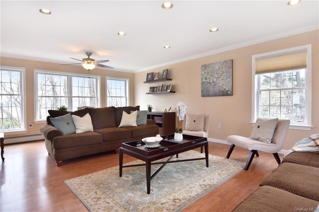 a living room with furniture a rug and a window