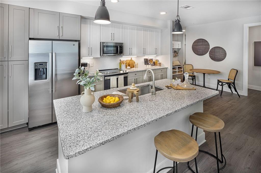 a kitchen with sink cabinets and stainless steel appliances