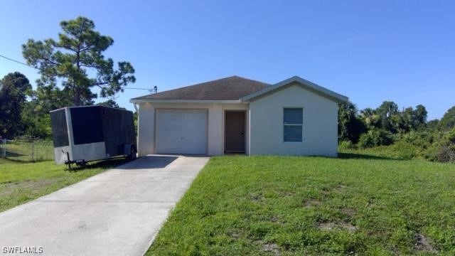 a front view of a house with a garden and yard