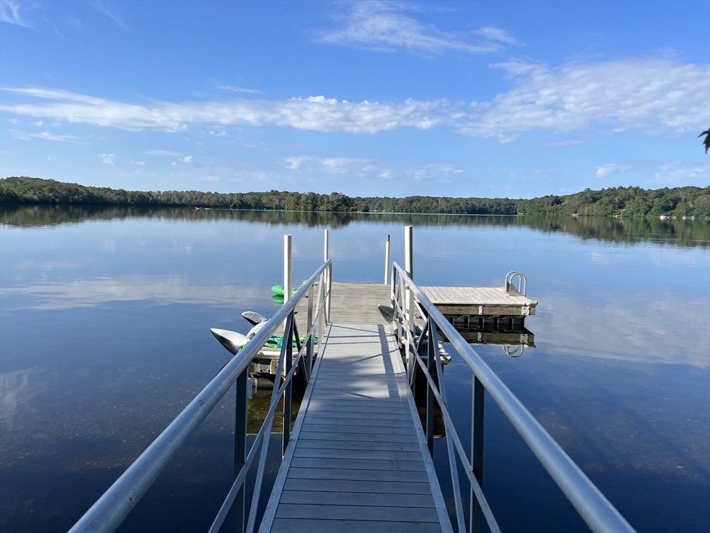 a view of a lake with wooden floor and city view