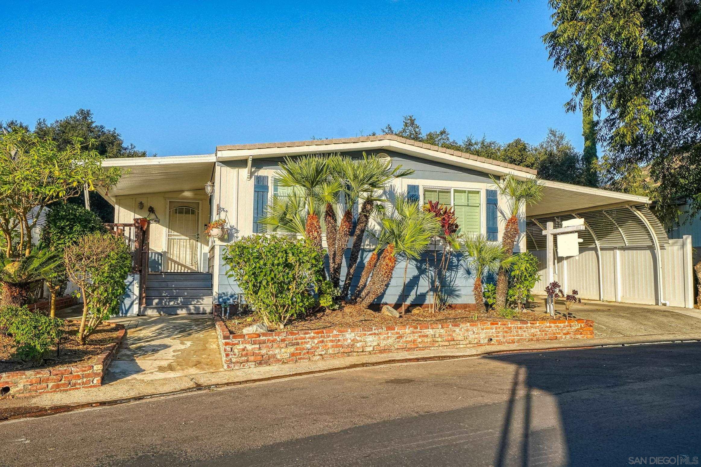 a front view of house along with trees