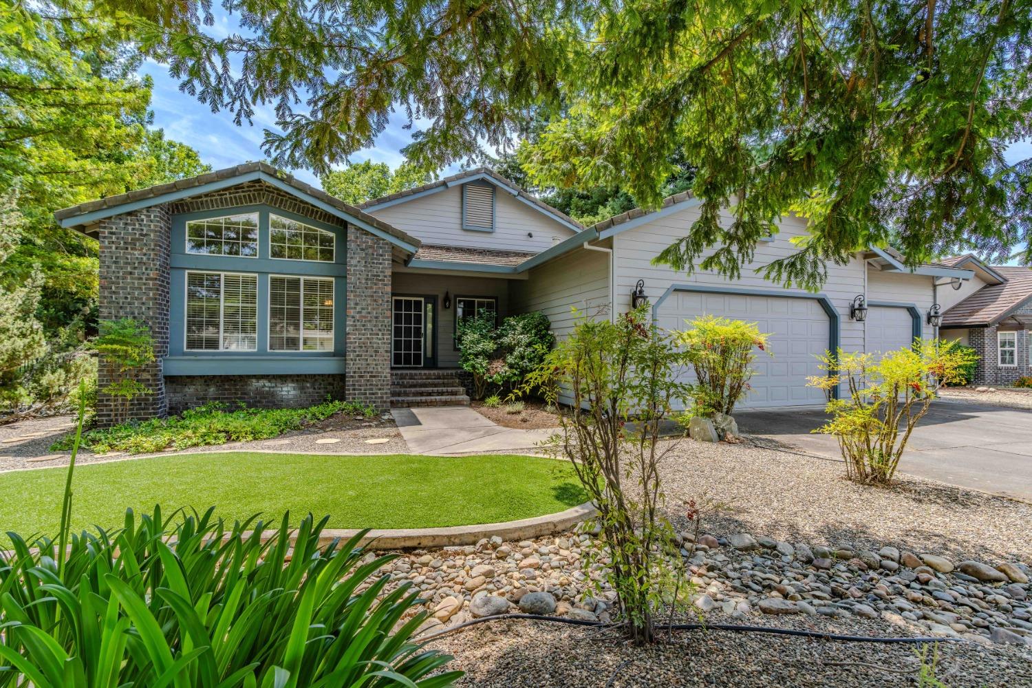 a front view of house with yard and green space