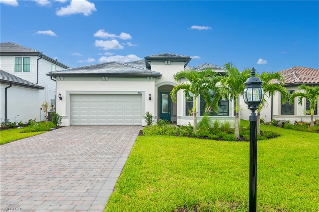 a front view of a house with a yard and garage