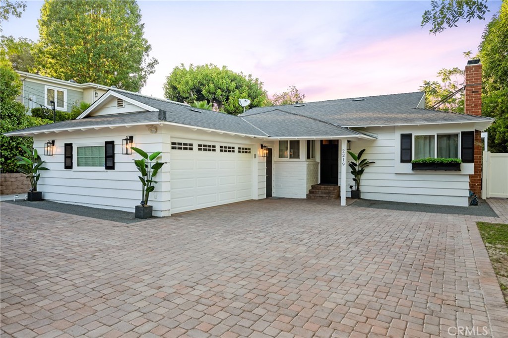 a view of a house with a yard and garage