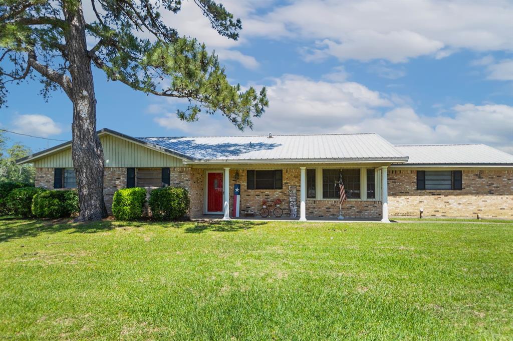 a front view of a house with a yard and porch