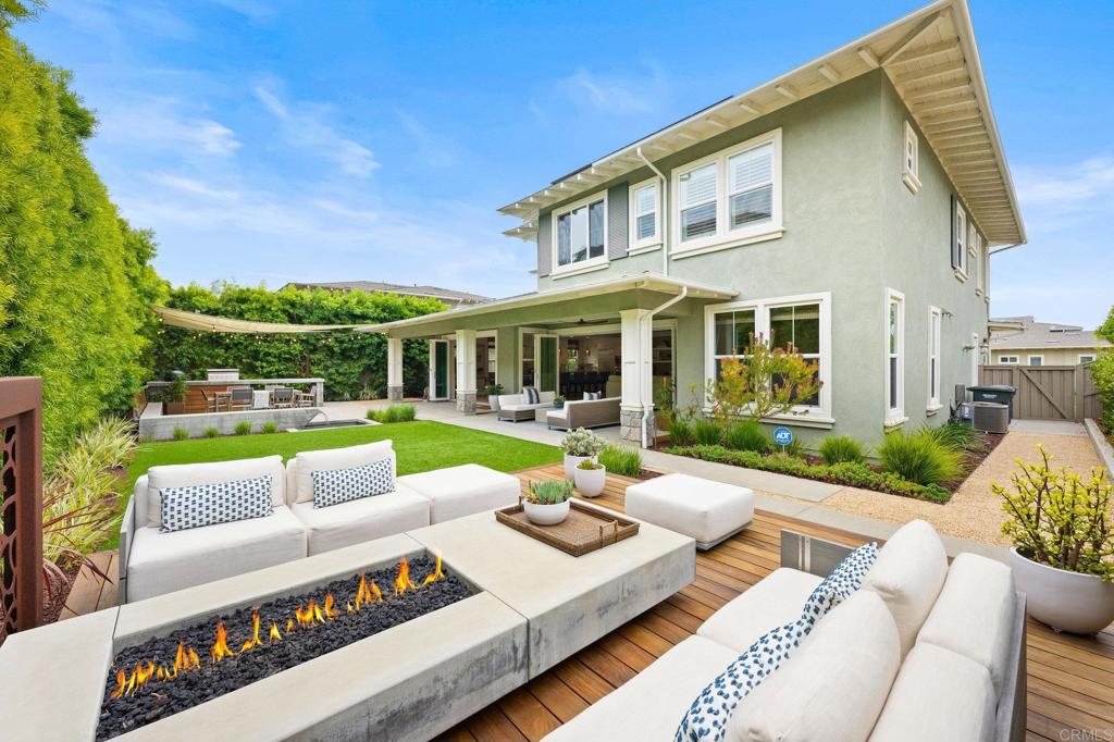 a view of a patio with couches chairs and a table and chairs with the view of lake