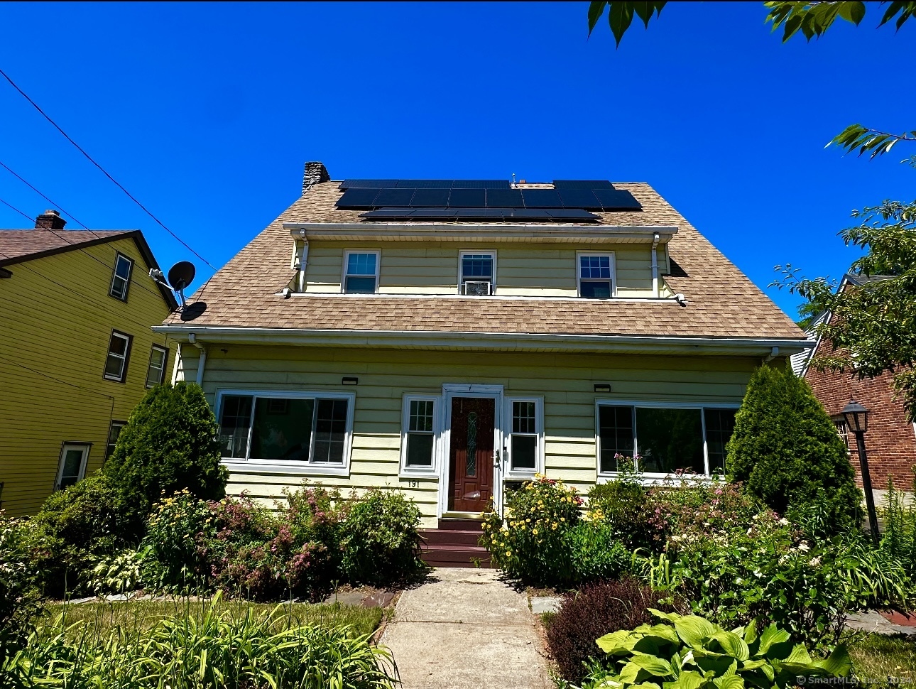 a front view of a house with garden