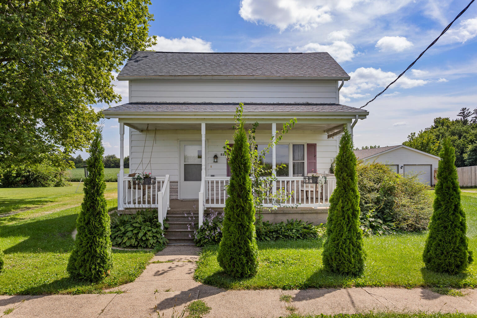 a front view of a house with a garden