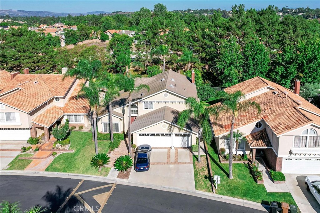 an aerial view of residential houses with outdoor space and street view