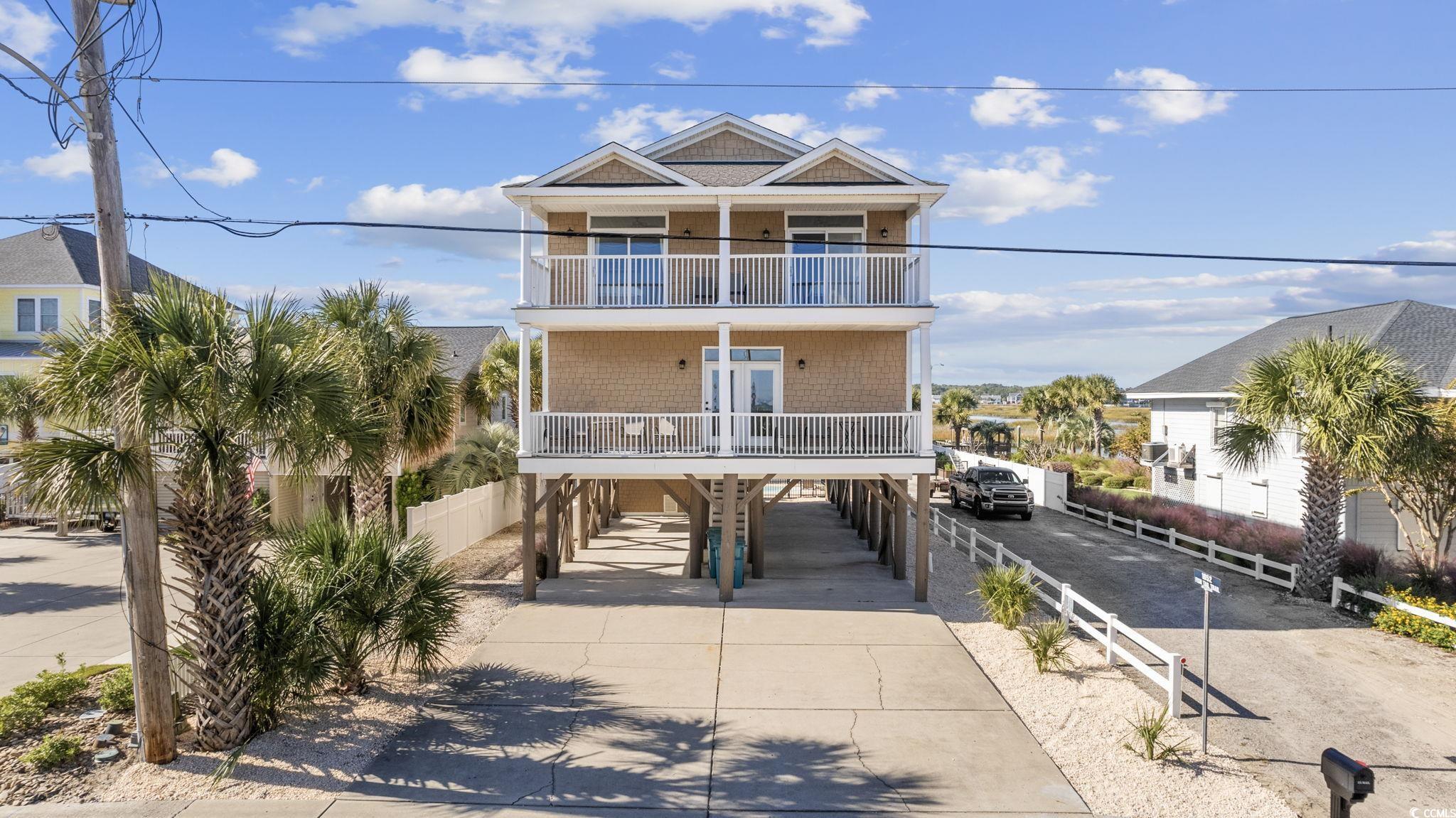 Beach home featuring a carport and a balcony