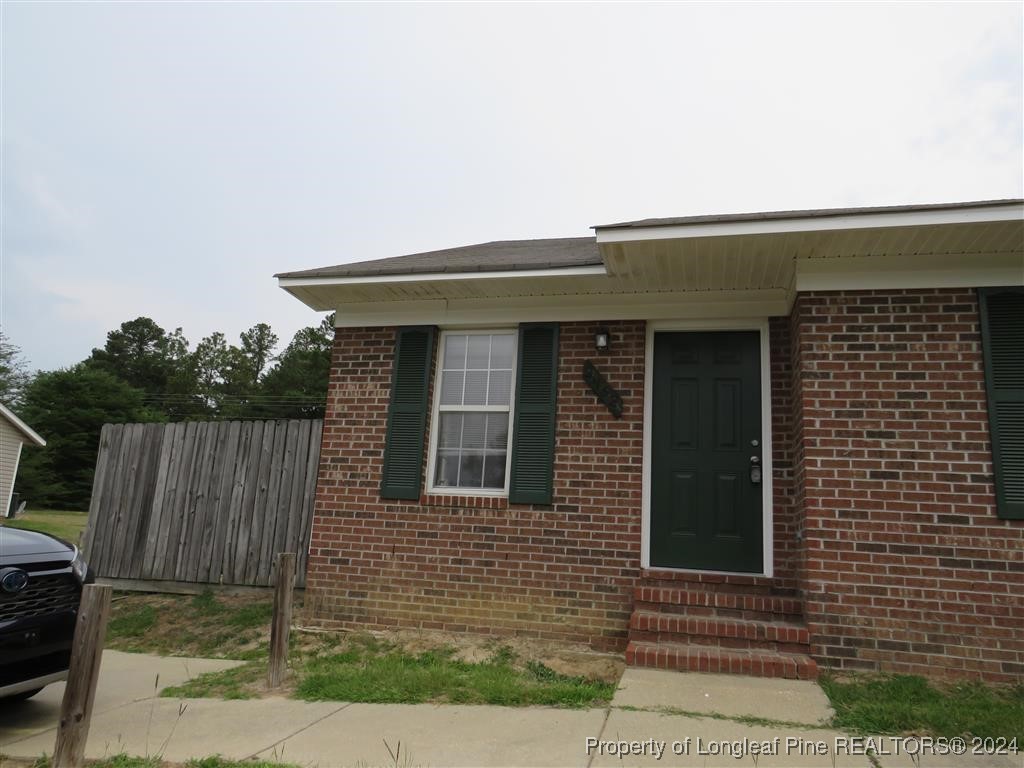 a front view of a house with fence