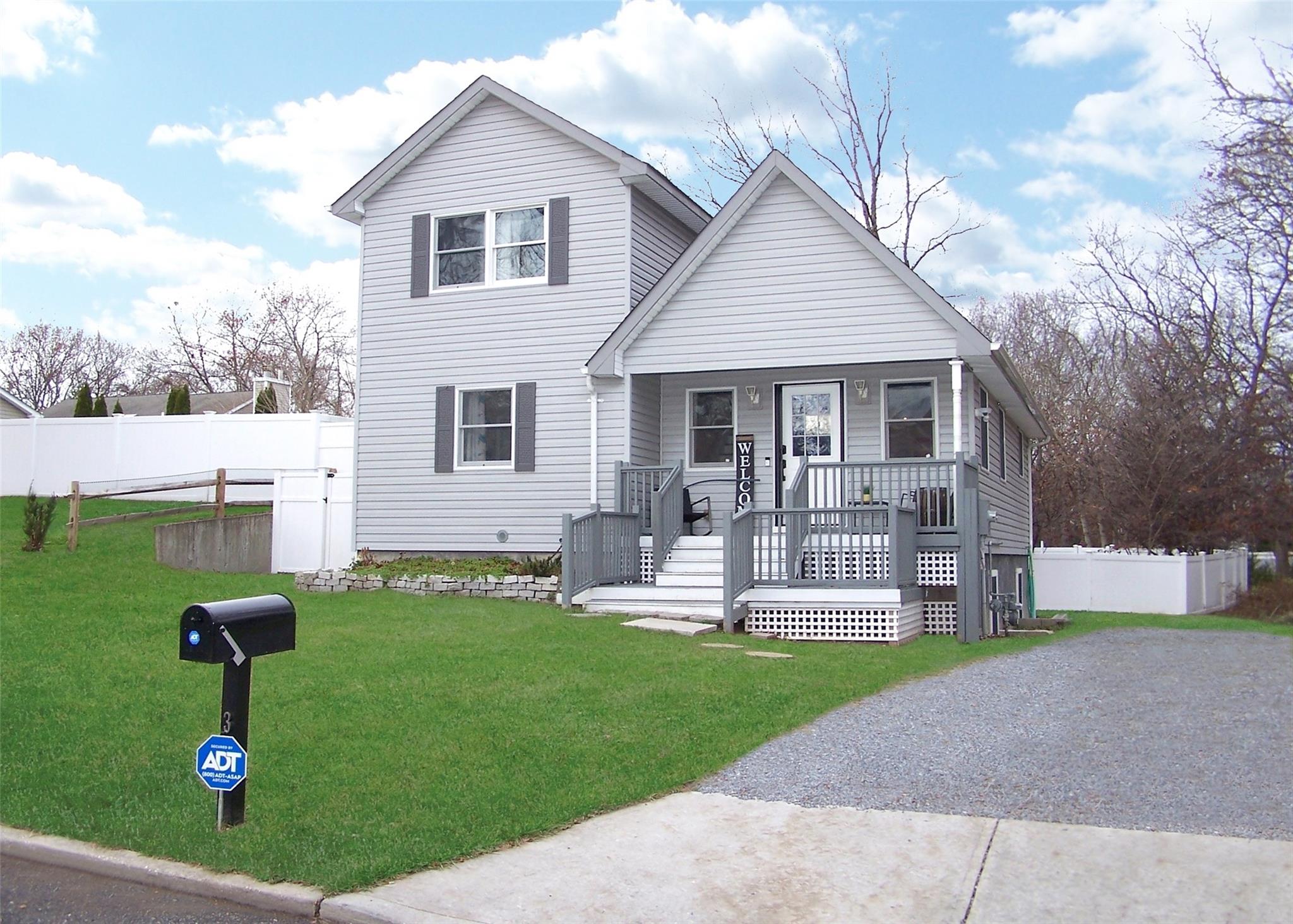 View of front property with a porch and a front yard