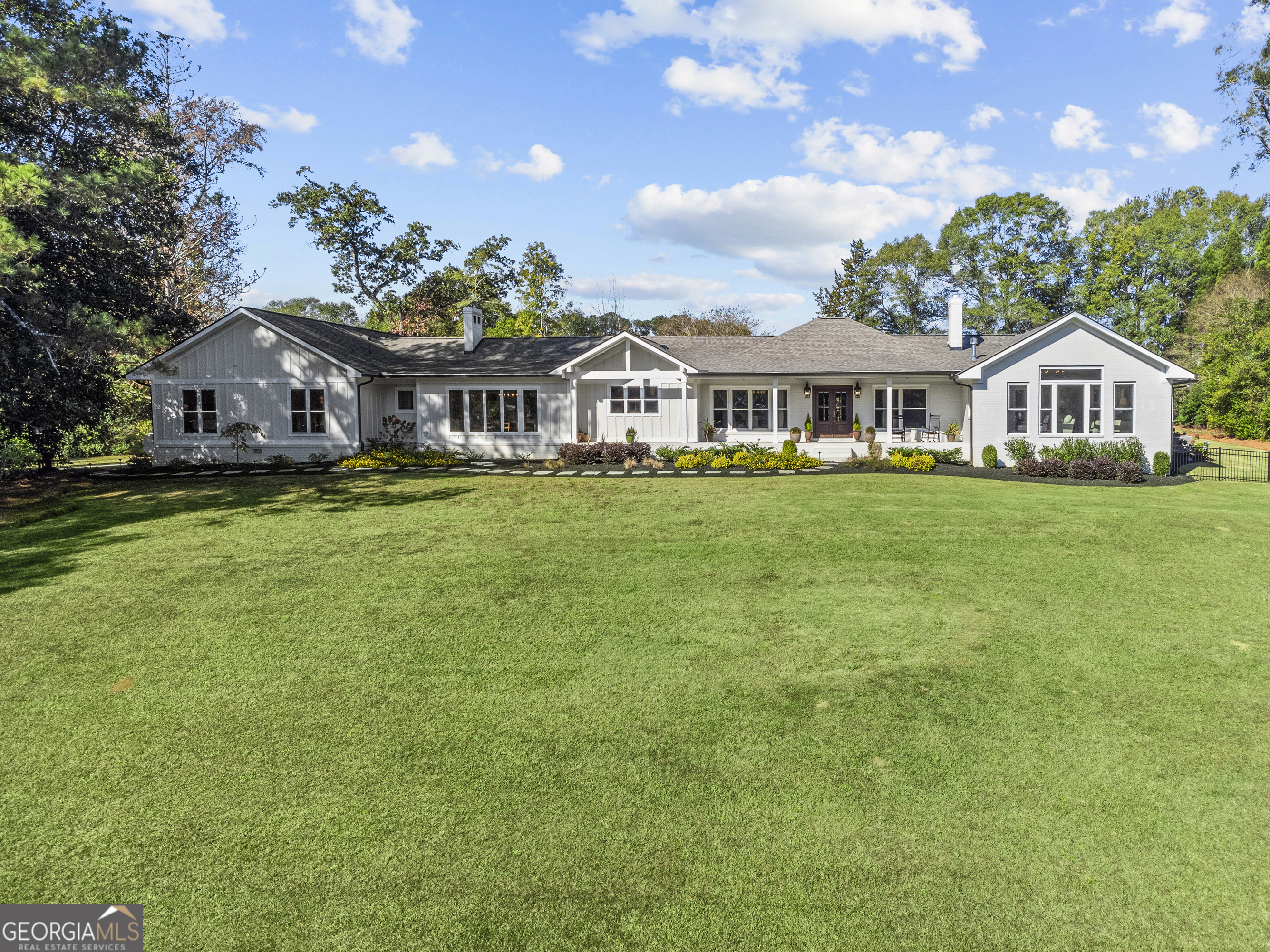 a front view of a house with a garden