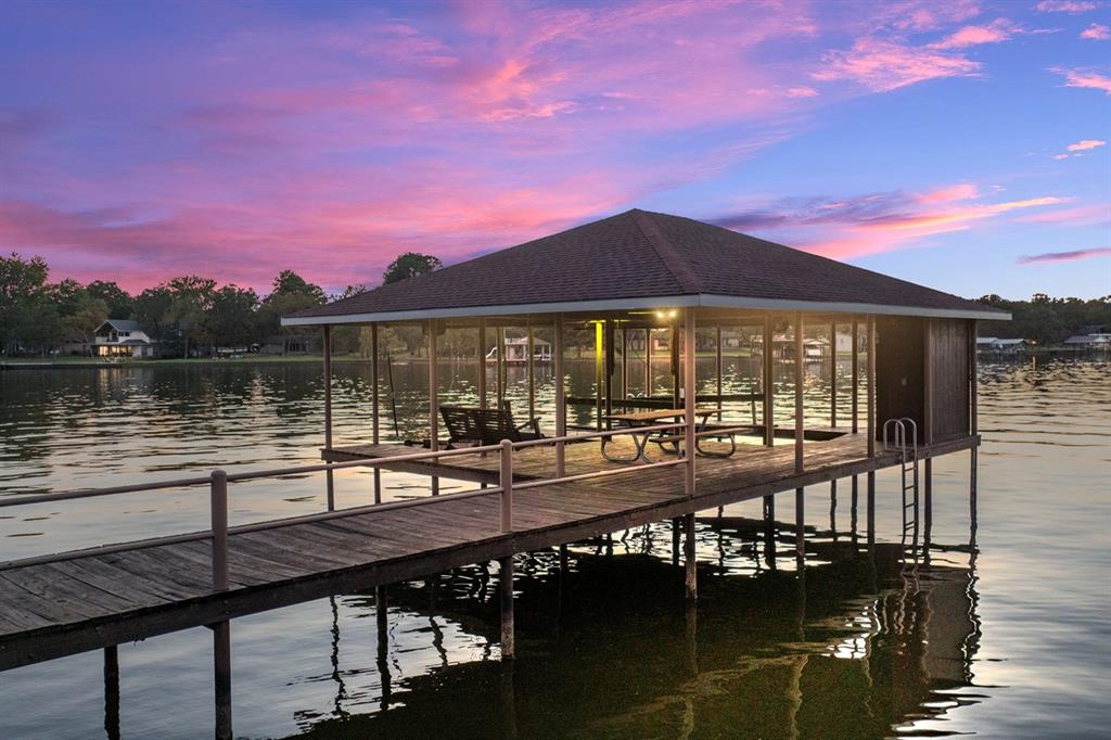 a view of a lake with a table and chairs