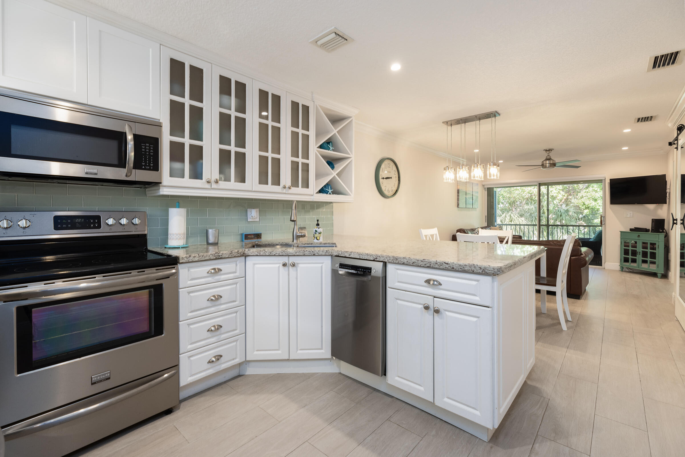 a kitchen with stainless steel appliances granite countertop a stove and cabinets