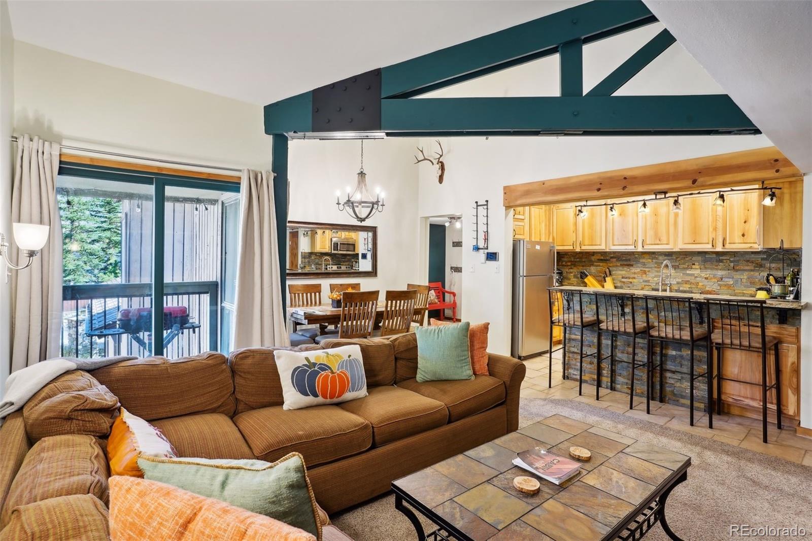 a living room with furniture and a floor to ceiling window