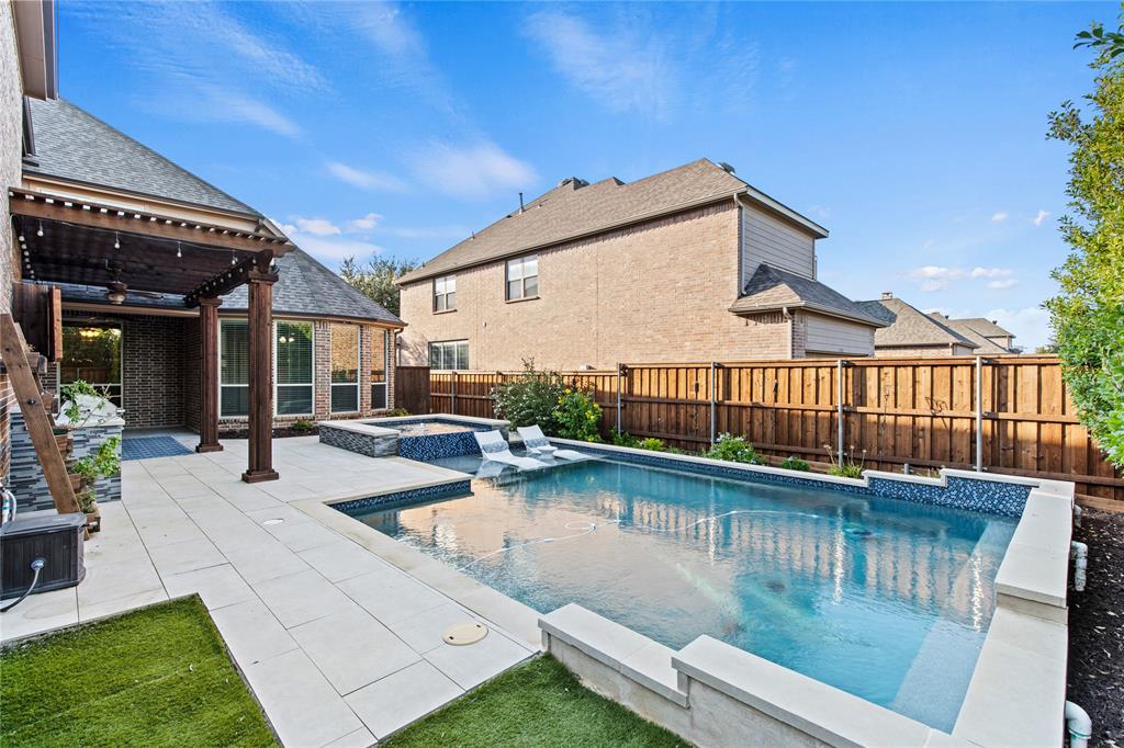 a view of a house with pool and sitting area