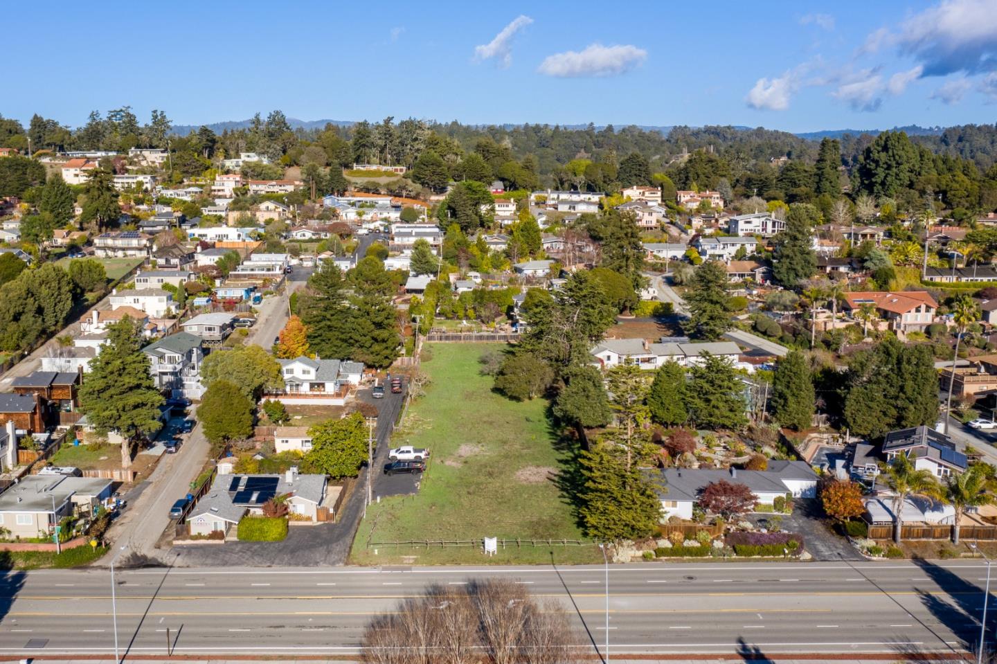 an aerial view of residential houses with outdoor space and street view