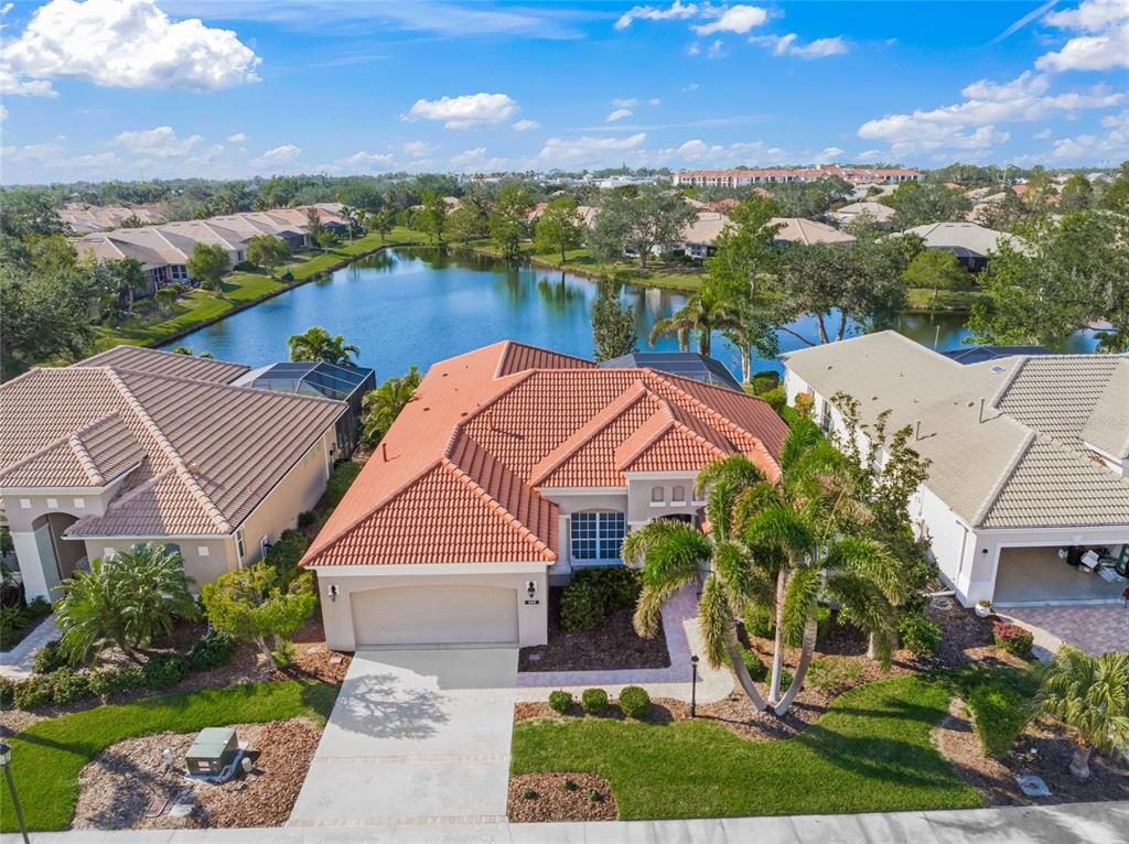 an aerial view of house with yard and ocean view