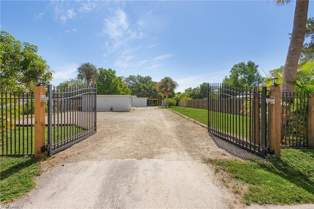 a view of a park with iron fence