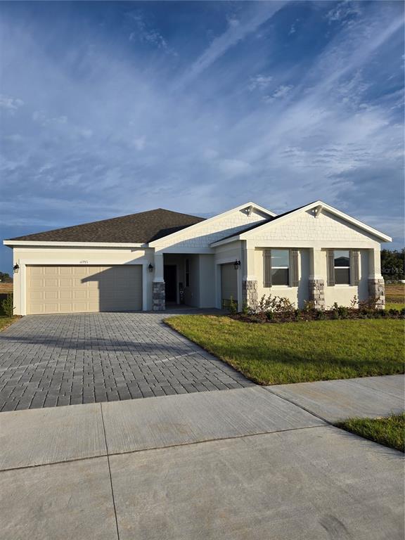 a front view of a house with a yard and garage