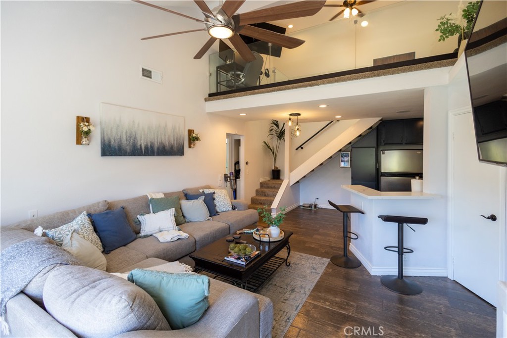 a living room with furniture and a painting on the wall