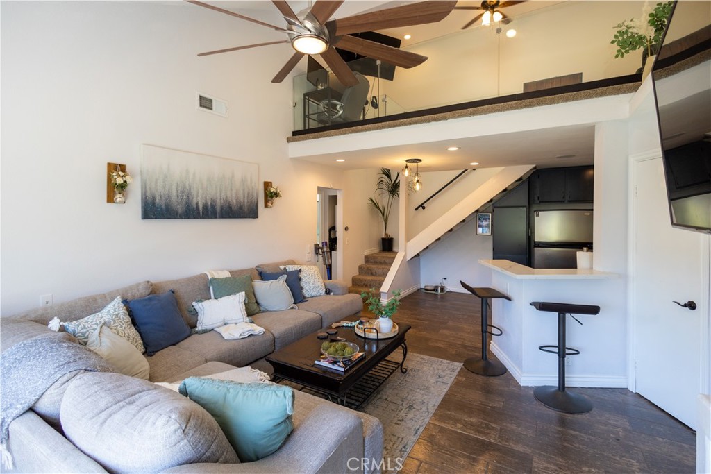 a living room with furniture and a ceiling fan