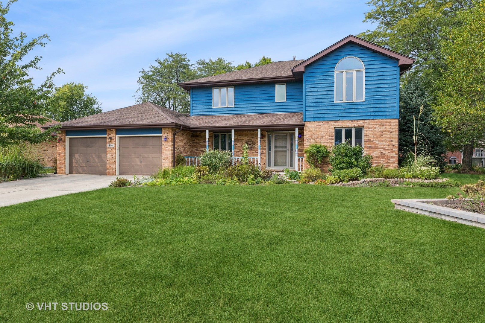 a view of a house with yard and a garden