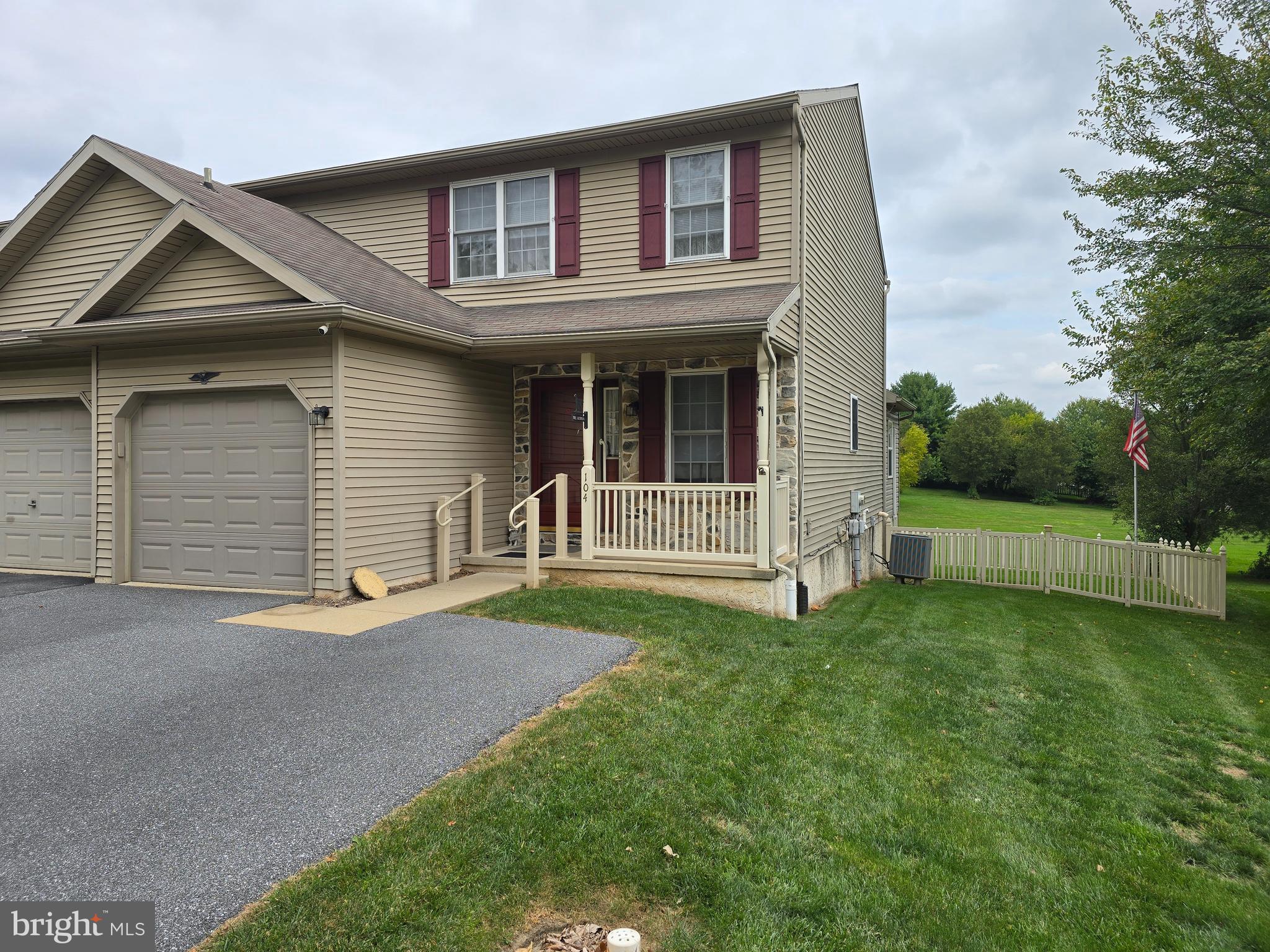 a view of a house with a yard and fence