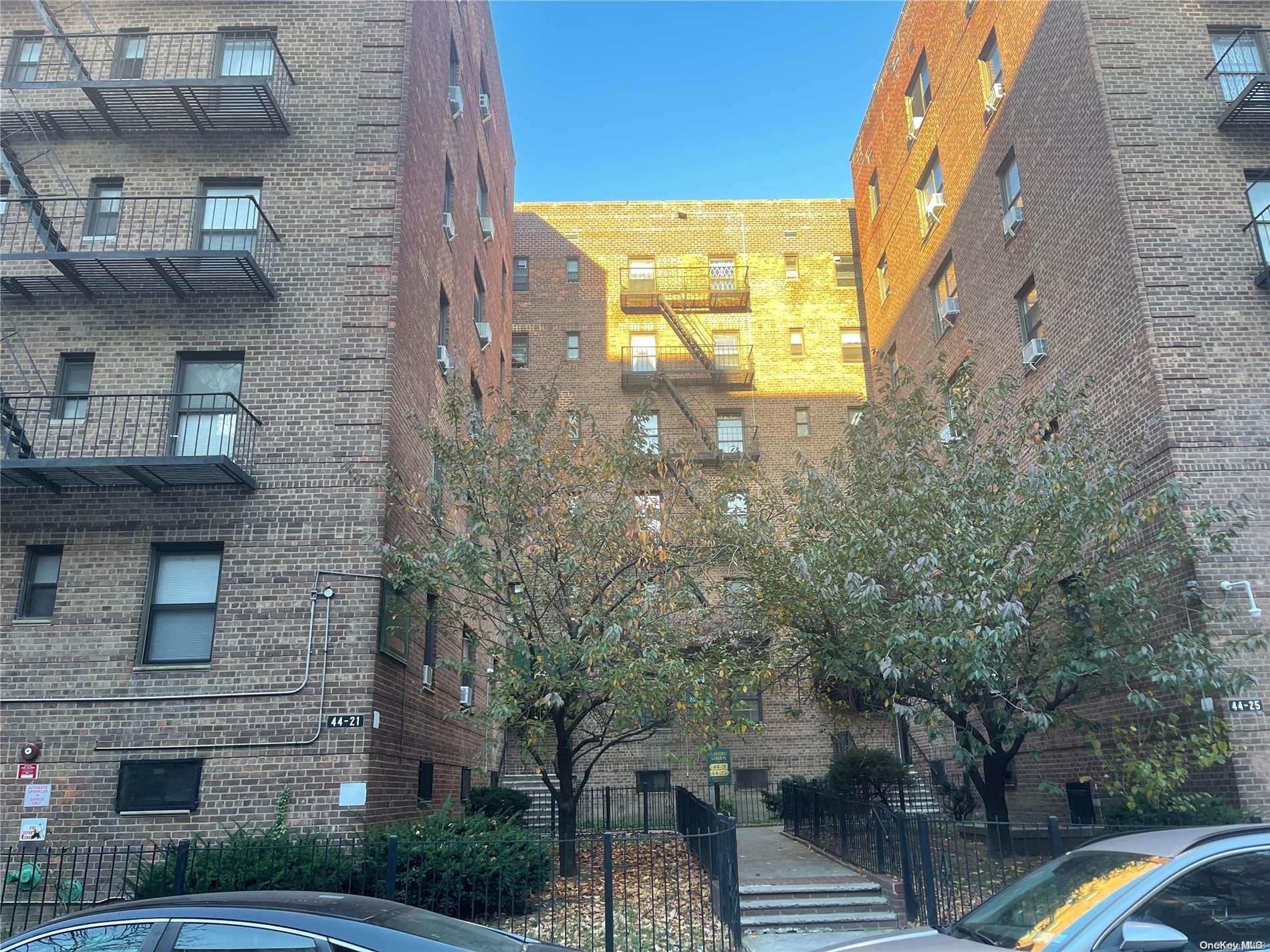 a brick building with a tree in front of it