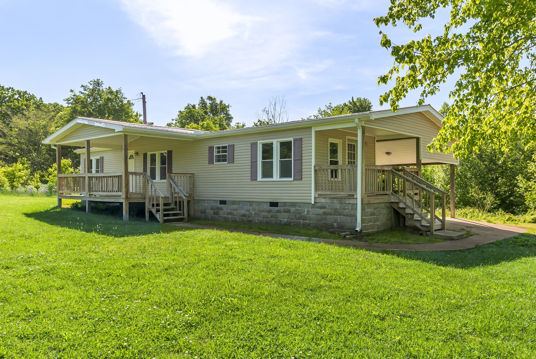 a view of a house with a yard porch and sitting area