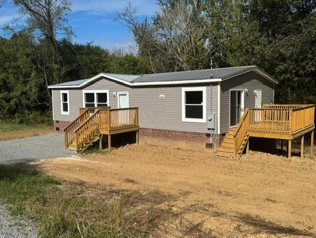 a view of a house with a yard and trees