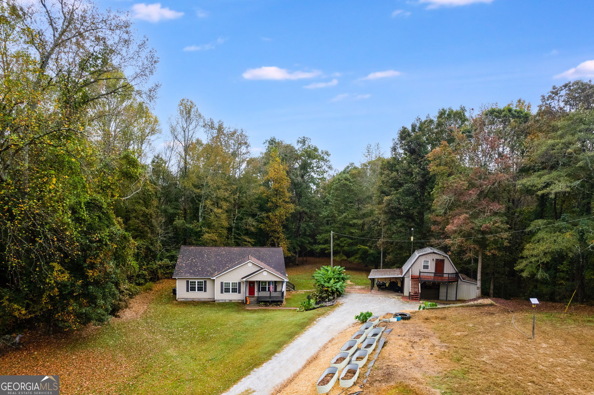 a view of a house with backyard and sitting area