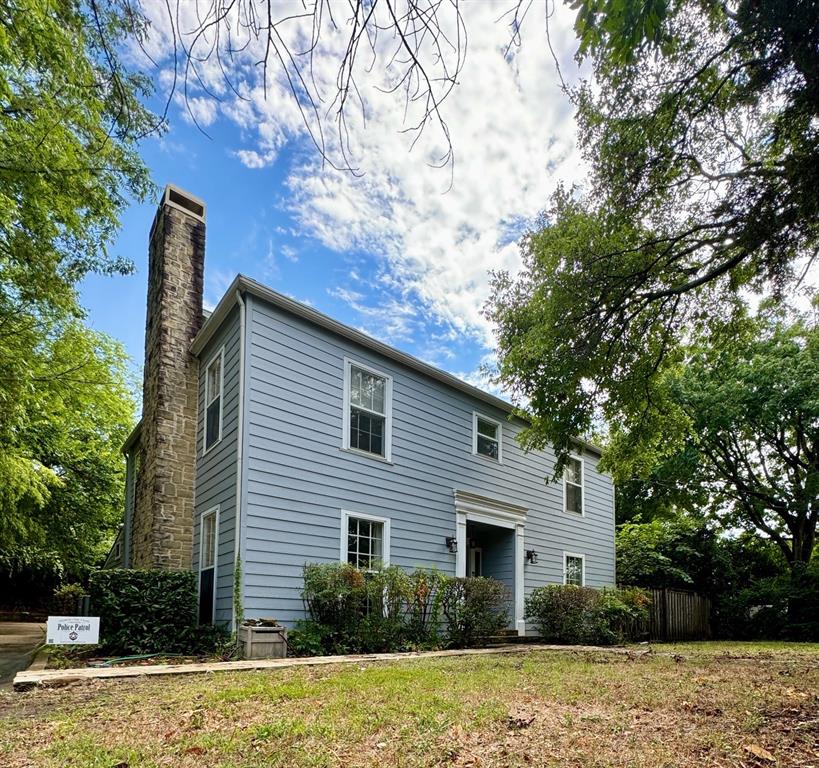 a house that has a tree in front of the house