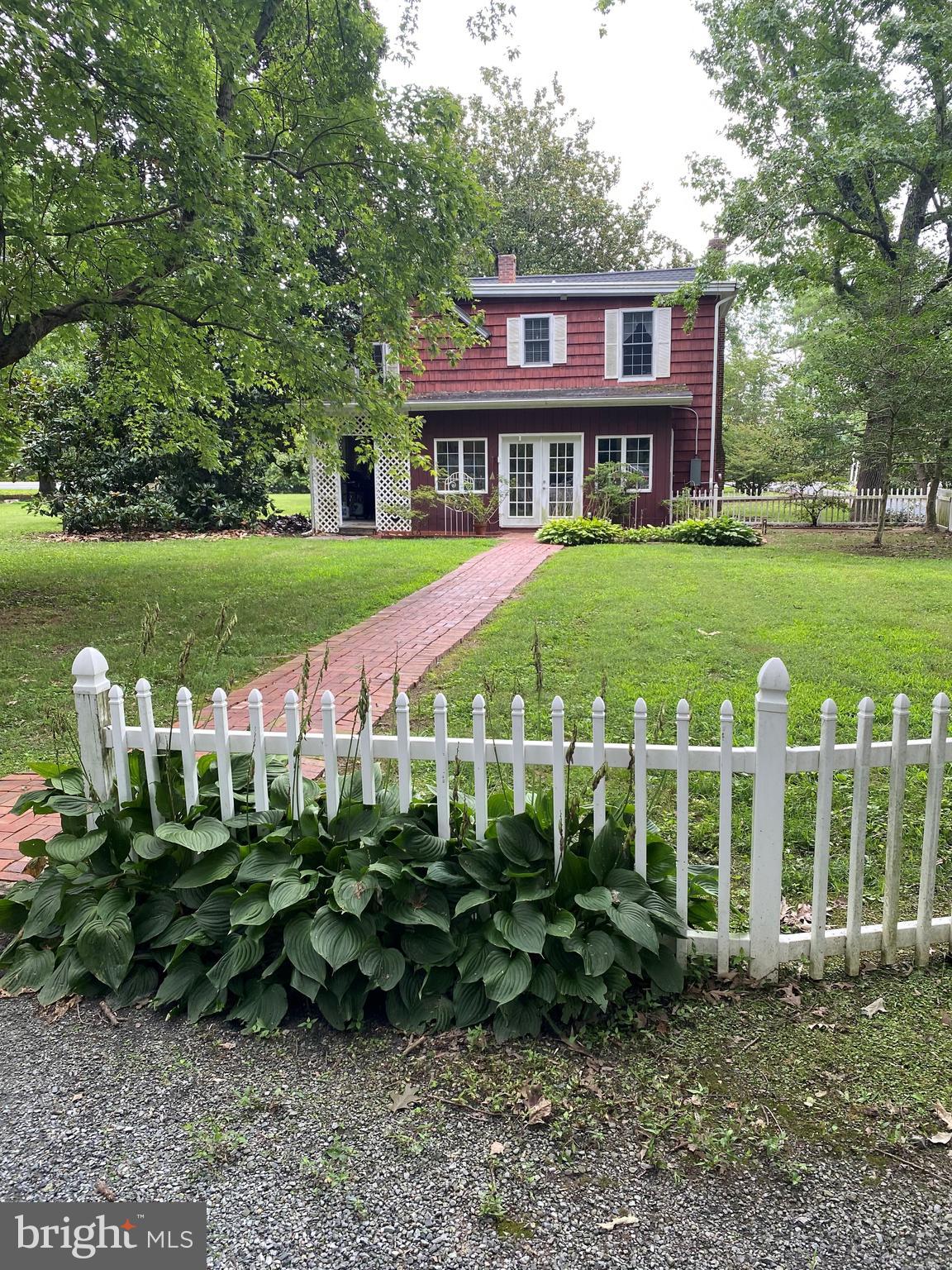 a view of a brick house with a yard