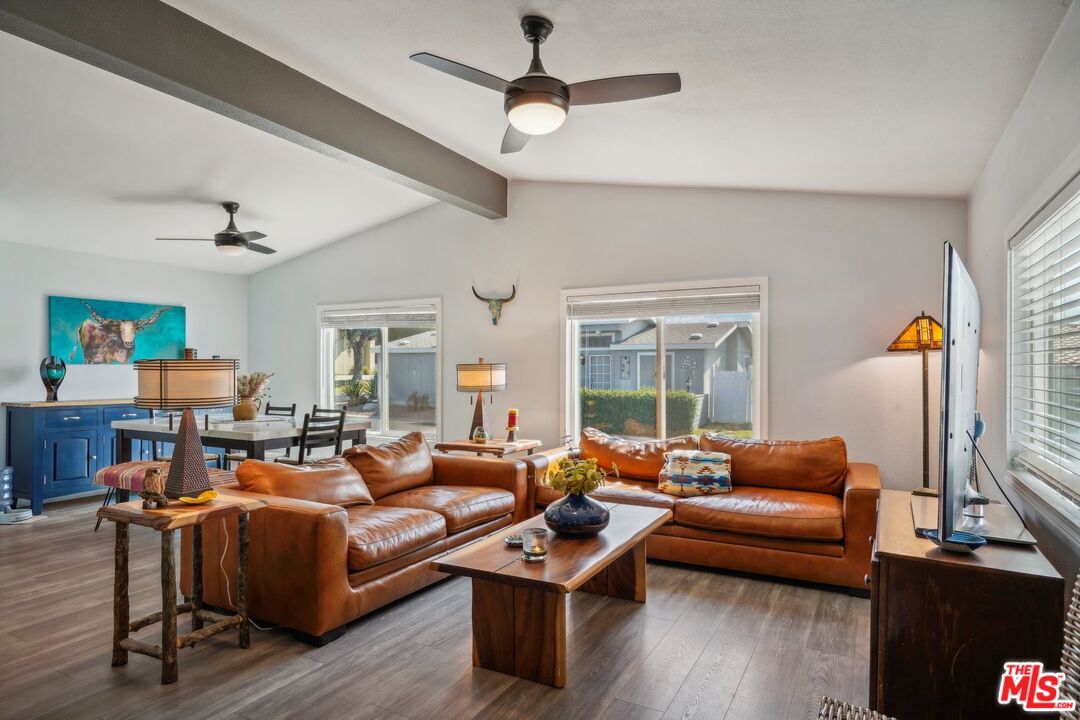 a living room with furniture a table and a large window