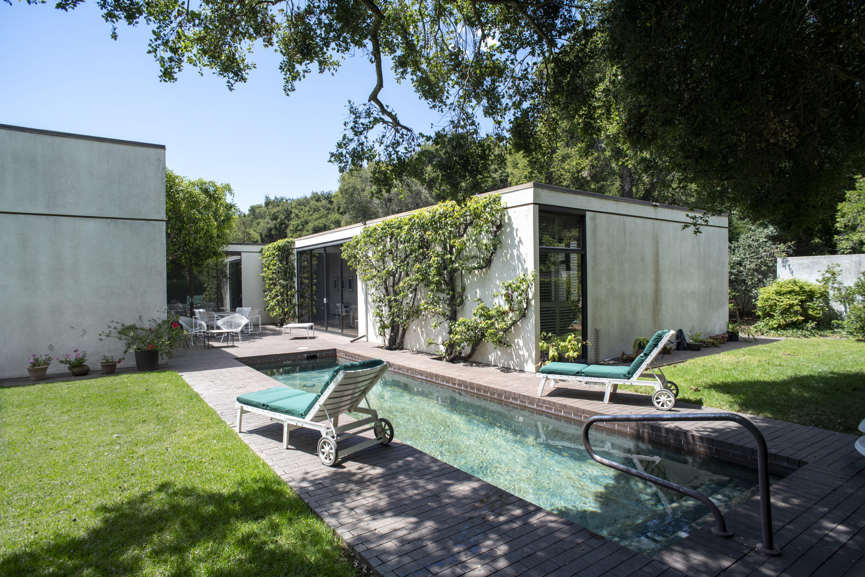 a view of a chair and table in backyard of the house