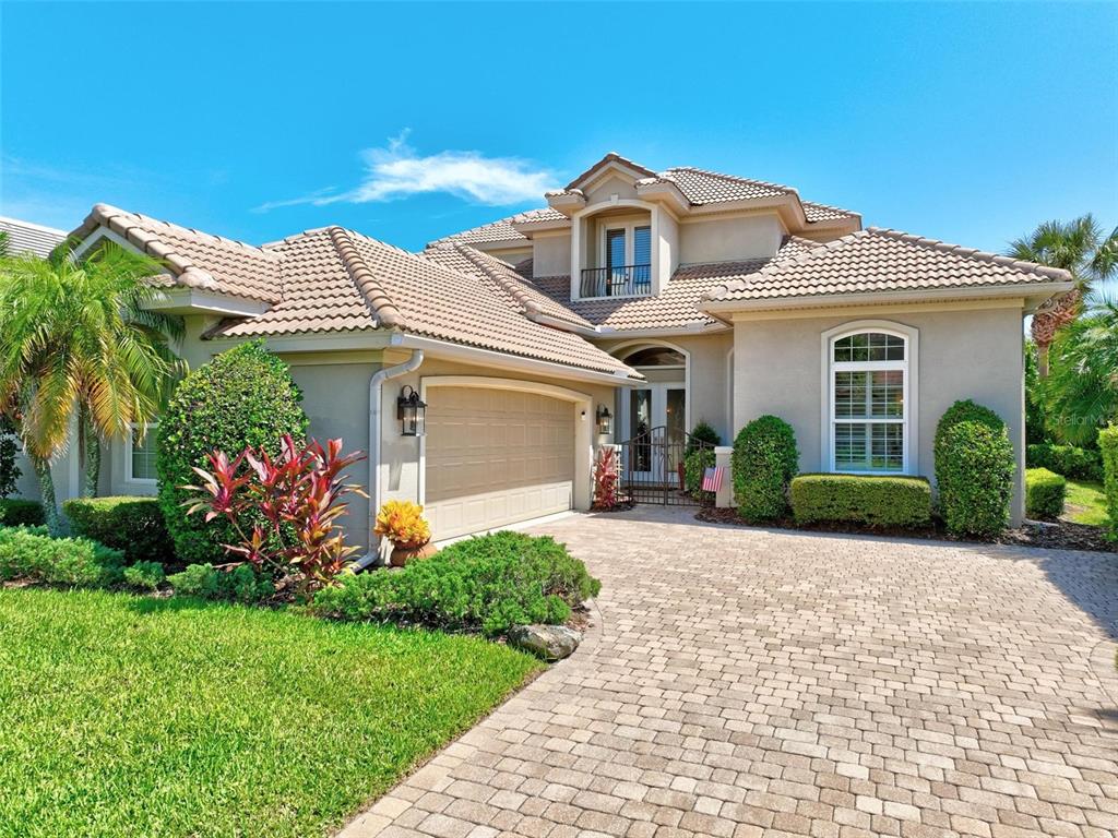 a front view of a house with a garden and plants