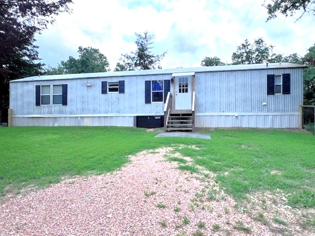 a view of a house with a backyard