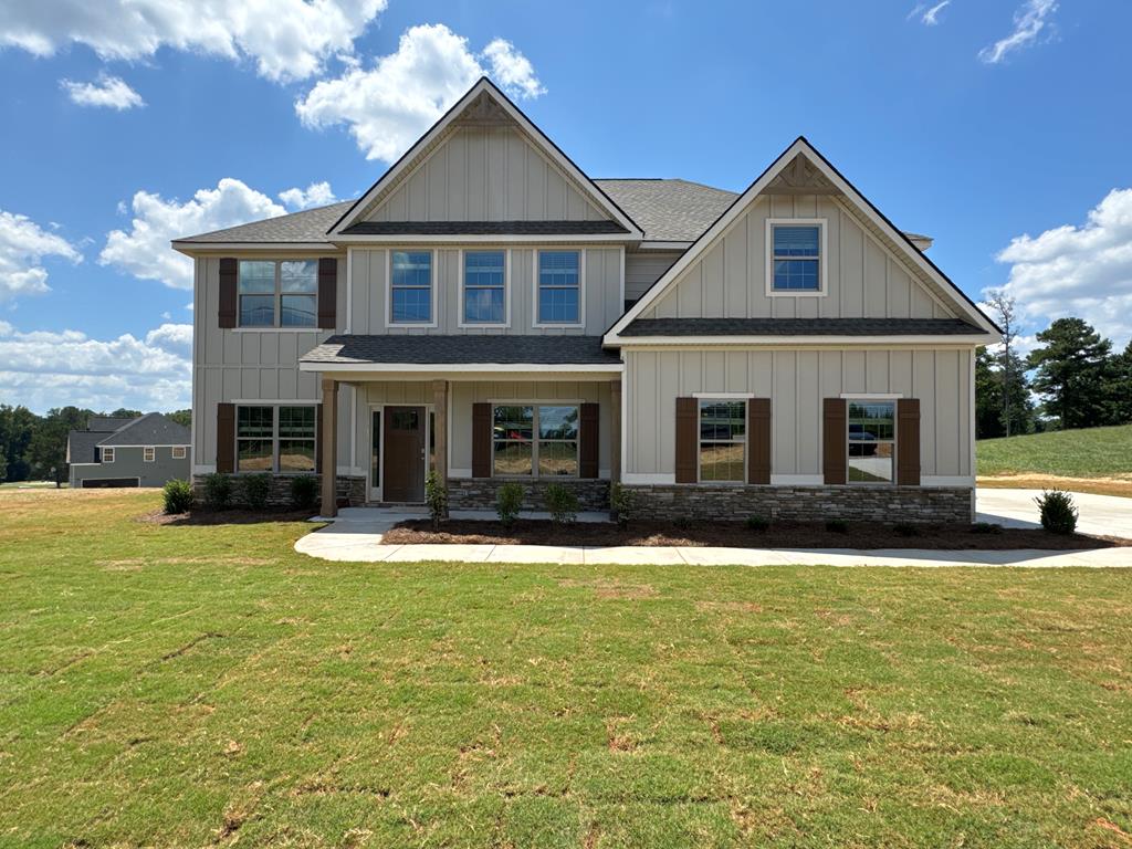 a front view of a house with swimming pool and front yard