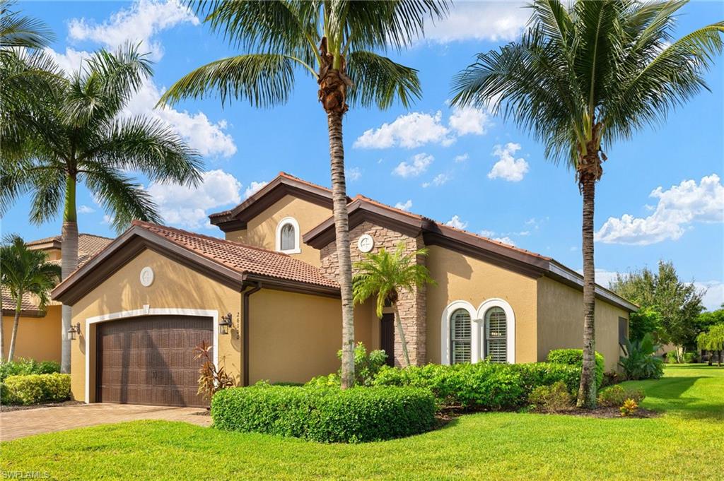 Mediterranean / spanish house with a front yard and a garage