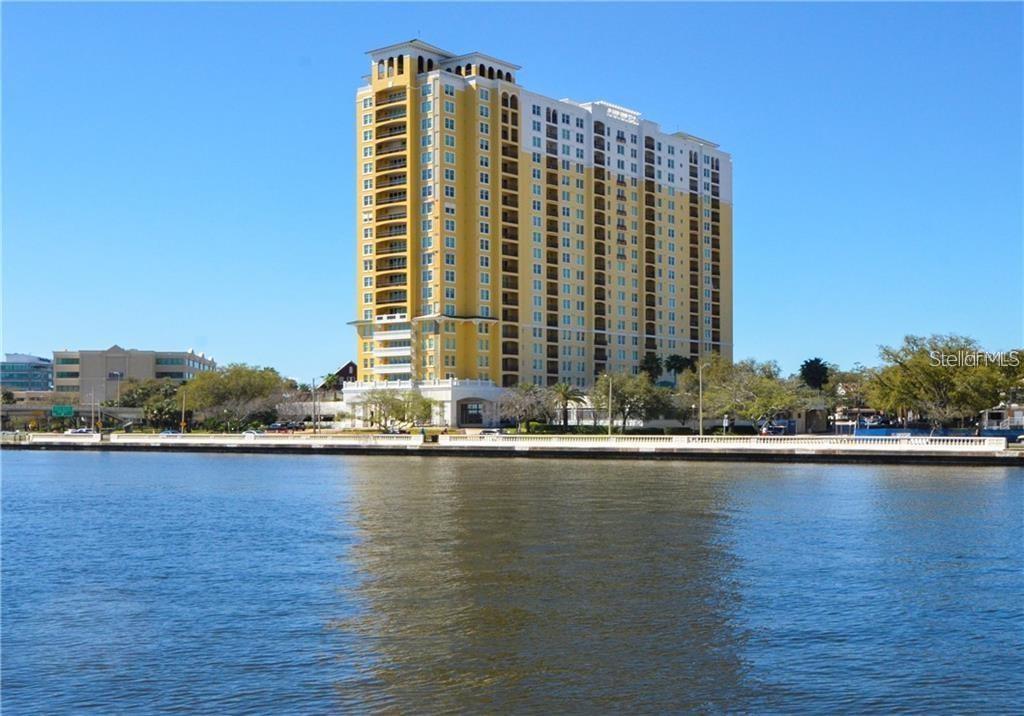 a view of a large building with swimming pool and ocean view