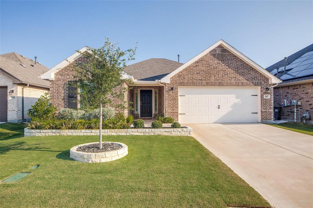 a view of a house with a yard and garage