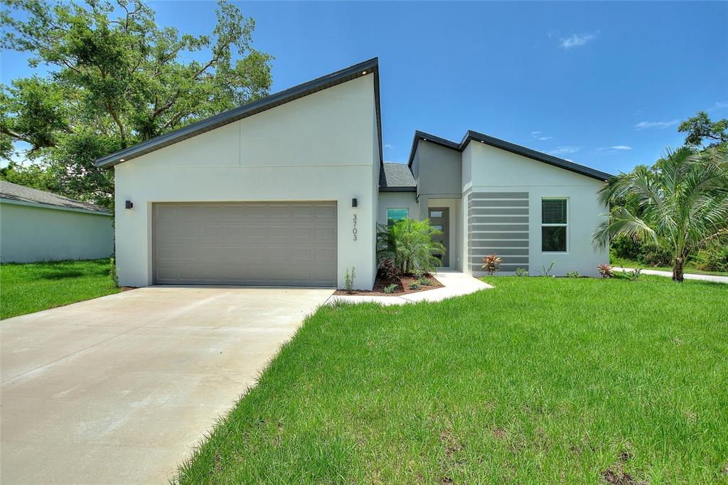 a front view of house with yard and green space